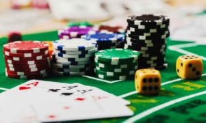 Casino table with poker chips, playing cards and dice in a close-up scene