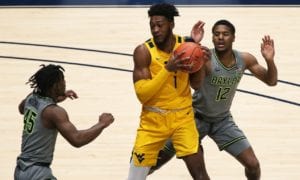 West Virginia forward Derek Culver (1) is defended by Baylor guards Davion Mitchell (45)