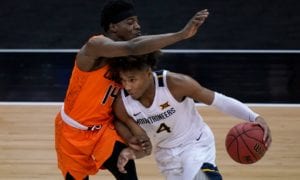 Oklahoma State's Bryce Williams (14) pressures West Virginia's Miles McBride (4)
