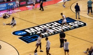 Players warm up on the court before the start of a First Four game