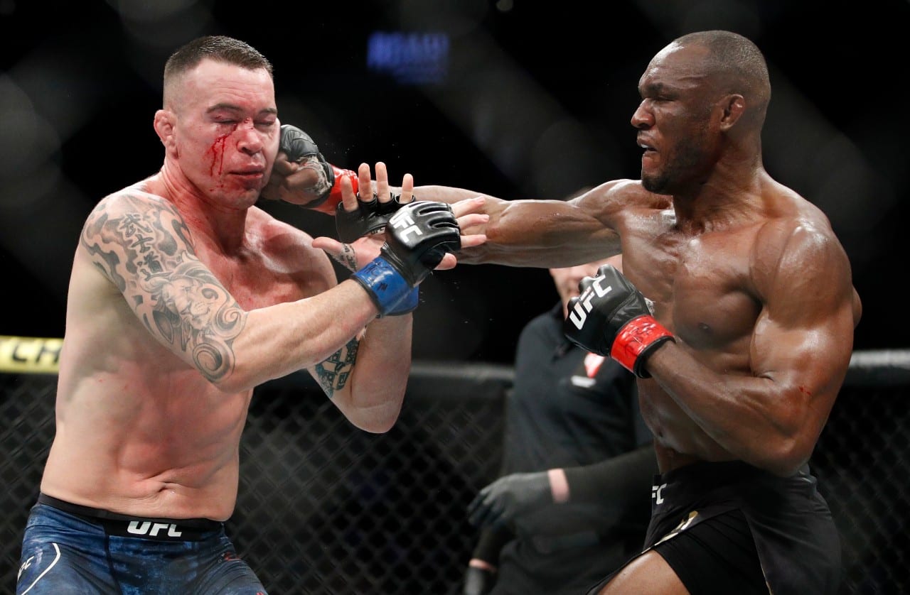 Kamaru Usman hits Colby Covington in a mixed martial arts welterweight championship bout