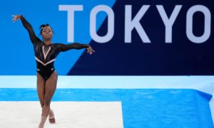 Simone Biles, of United States, trains on the floor for the artistic gymnastics