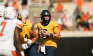 West Virginia quarterback Jarret Doege (2) looks for an open teammate