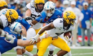 West Virginia running back Leddie Brown (4) slips past the Kansas defense