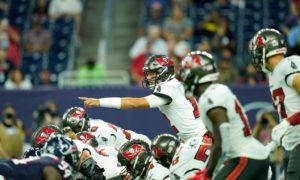 Tampa Bay Buccaneers quarterback Tom Brady (12) points over the line of scrimmage