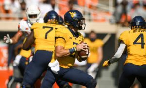 West Virginia quarterback Jarret Doege (2) looks for a receiver