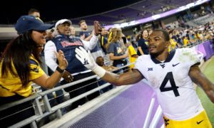 West Virginia running back Leddie Brown (4) celebrates with fans