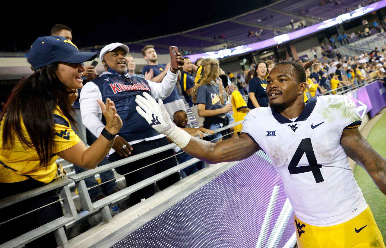 West Virginia running back Leddie Brown (4) celebrates with fans