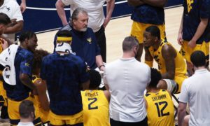 West Virginia coach Bob Huggins speaks with players during the second half