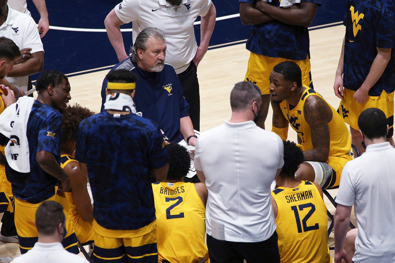 West Virginia coach Bob Huggins speaks with players during the second half