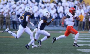Oklahoma State quarterback Spencer Sanders (3) runs while defended by West Virginia linebacker