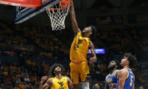 West Virginia guard Taz Sherman (12) shoots while defended by Pittsburgh