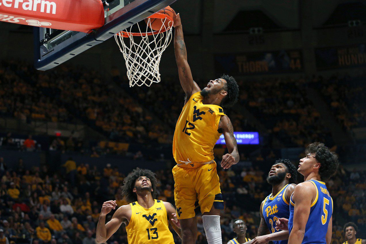 West Virginia guard Taz Sherman (12) shoots while defended by Pittsburgh