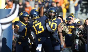 West Virginia wide receiver Sean Ryan (10) celebrates after he scores a touchdown against Texas