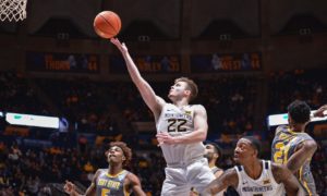 West Virginia guard Sean McNeil (22) makes a layup against Kent State