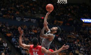 West Virginia guard Taz Sherman (12) shoots over Radford