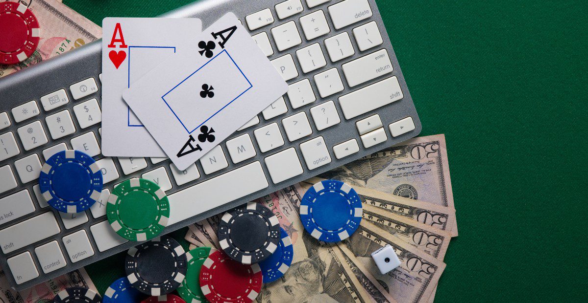 Image showing online casino gaming with chips and playing cards on a keyboard for a story about the West Virginia market setting a new online casino revenue record for the year with over $150 million.