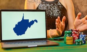 Image showing a poker player with chips along with a laptop showing the WV state outline for a story about an update on when online poker will officially launch in the Mountain State.